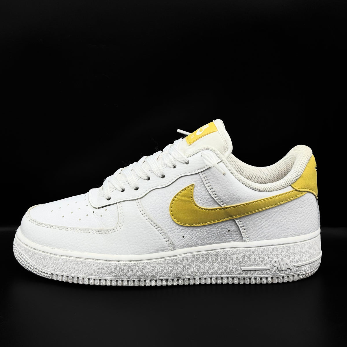 Nike Air Force 1 Low in white and Saturn Gold