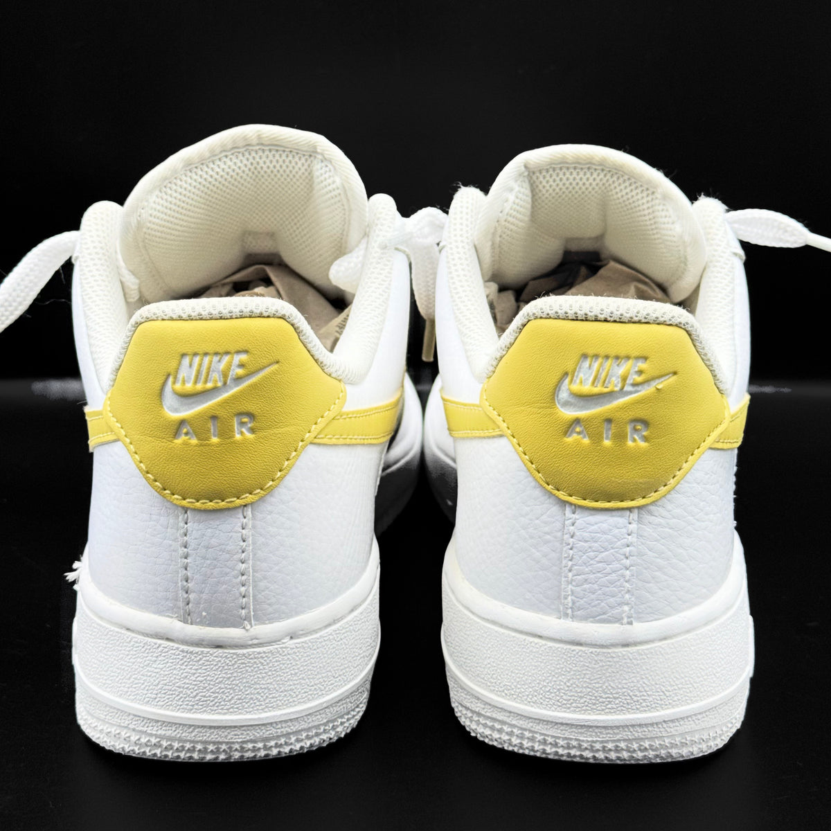Nike Air Force 1 Low in white and Saturn Gold