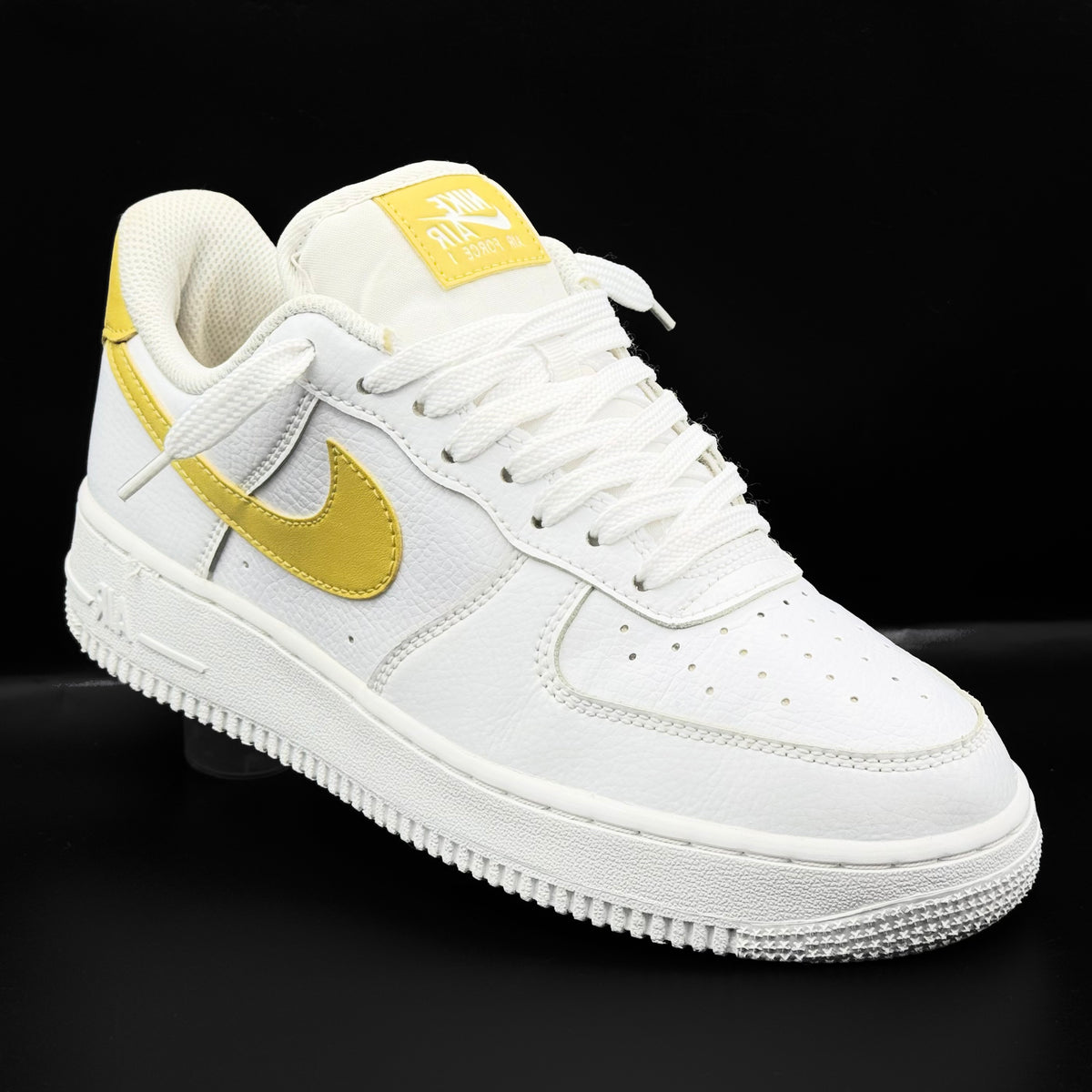 Nike Air Force 1 Low in white and Saturn Gold