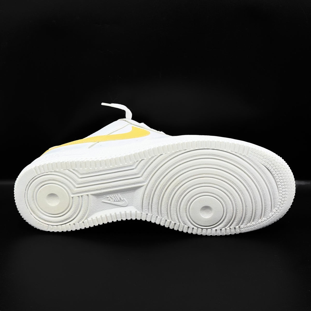 Nike Air Force 1 Low in white and Saturn Gold