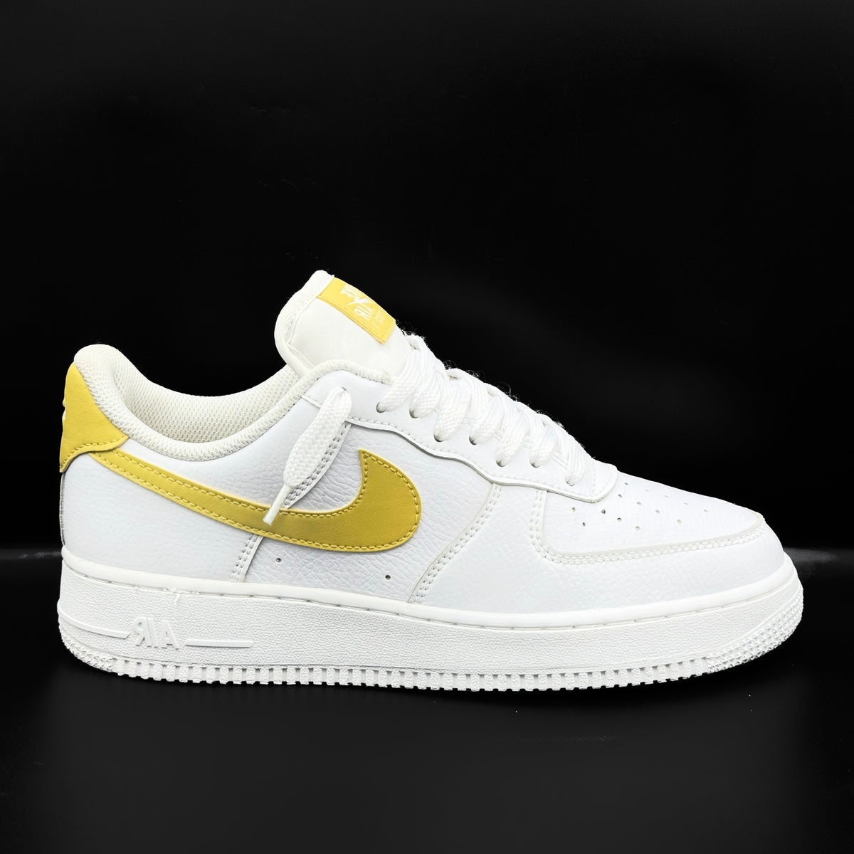 Nike Air Force 1 Low in white and Saturn Gold