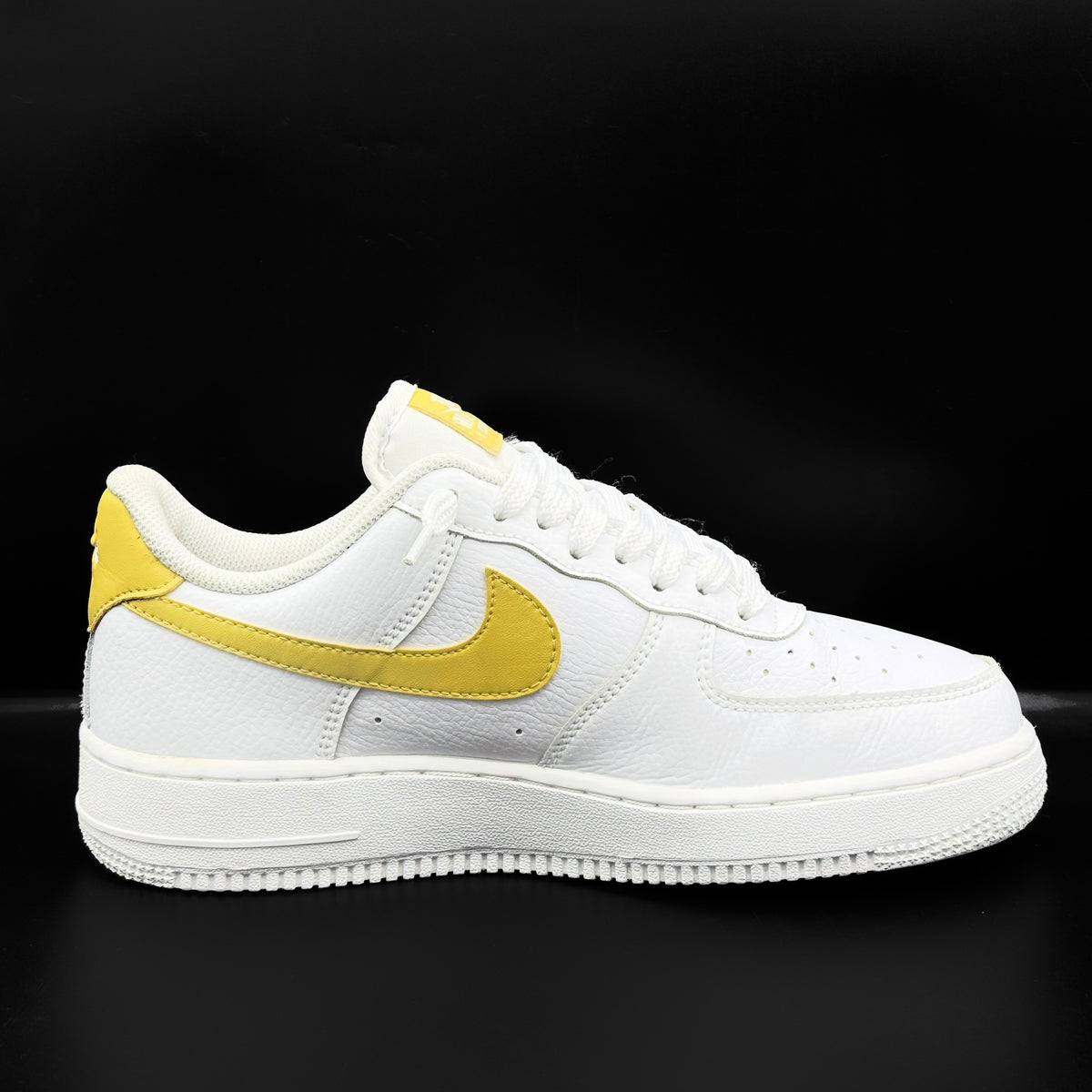 Nike Air Force 1 Low in white and Saturn Gold