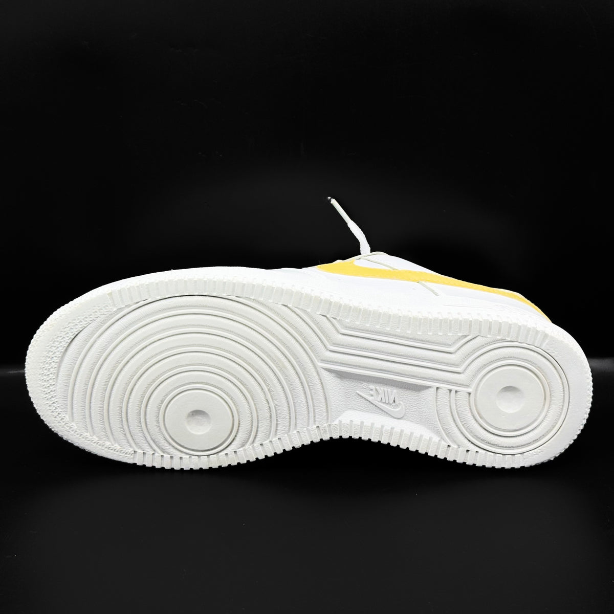 Nike Air Force 1 Low in white and Saturn Gold