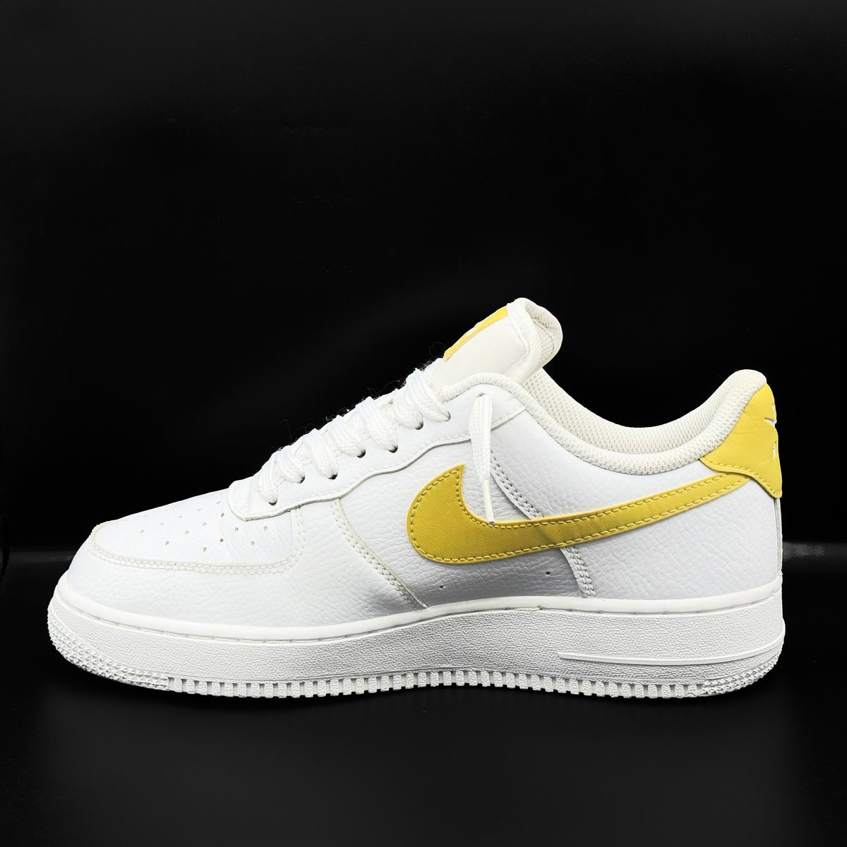 Nike Air Force 1 Low in white and Saturn Gold